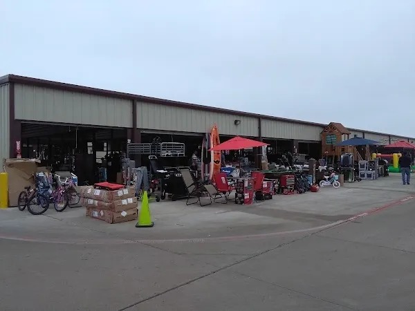 Warehouse lot with wholesale goods displayed outside loading bays